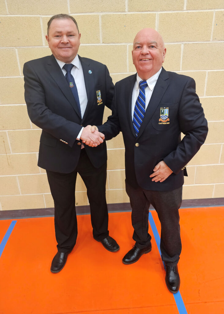 Outgoing Captain, Trevor Davies, congratulates Paul Lemon on his election as 2026 Club Captain at the 2025 AGM
